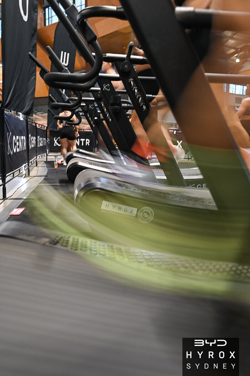 Hybrid athlete running during HYROX-style race preparation