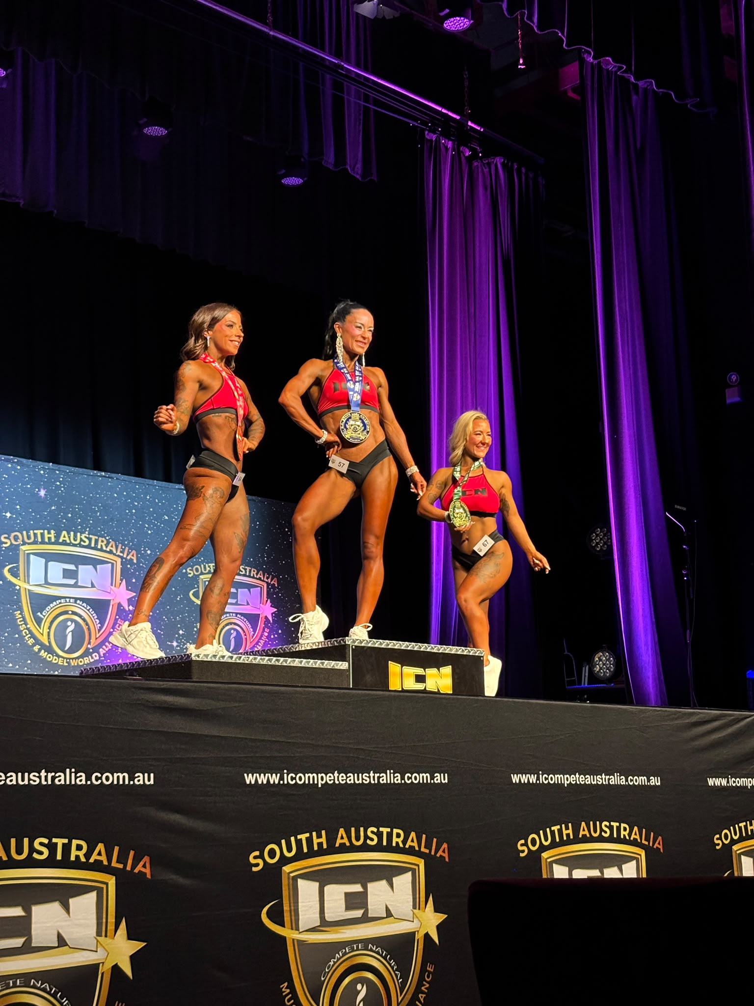 TPC client on the top step of the podium at a bodybuilding competition